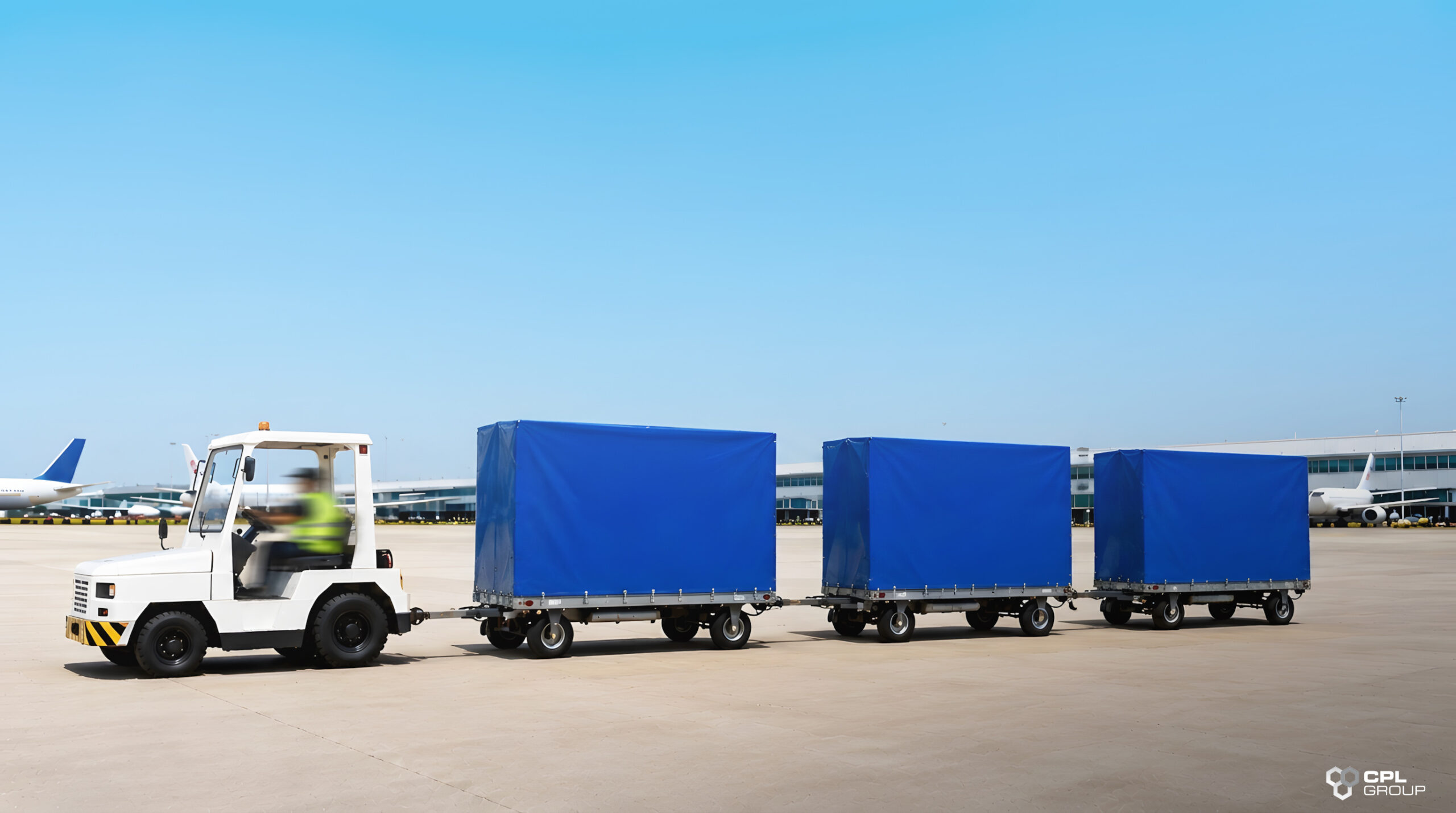 Airport baggage trolleys protected with durable covers on an airport apron